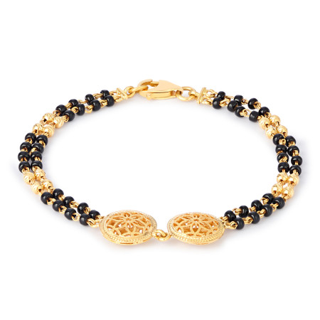 22ct Gold Black Bead Bracelet with Floral Disc Motifs 22ct Gold Black Bead Bracelet with Floral Disc Motifs